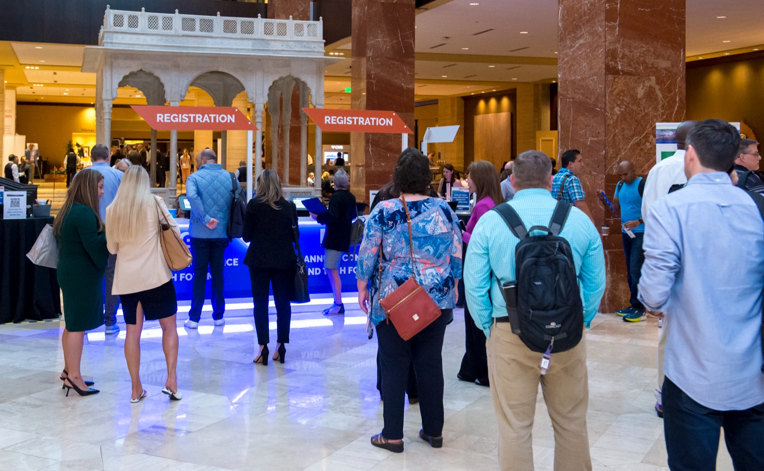 A group of people at a registration desk