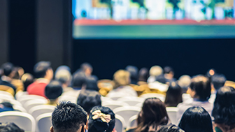 group of conference attendees listening to a presentation