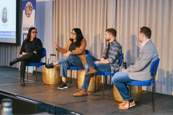 Four people sitting on stage during the London Summit 26