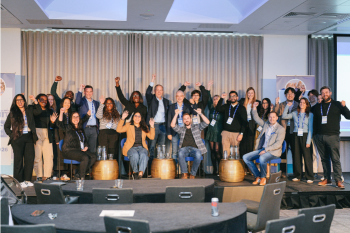 Group of attendees on stage celebrating the conference