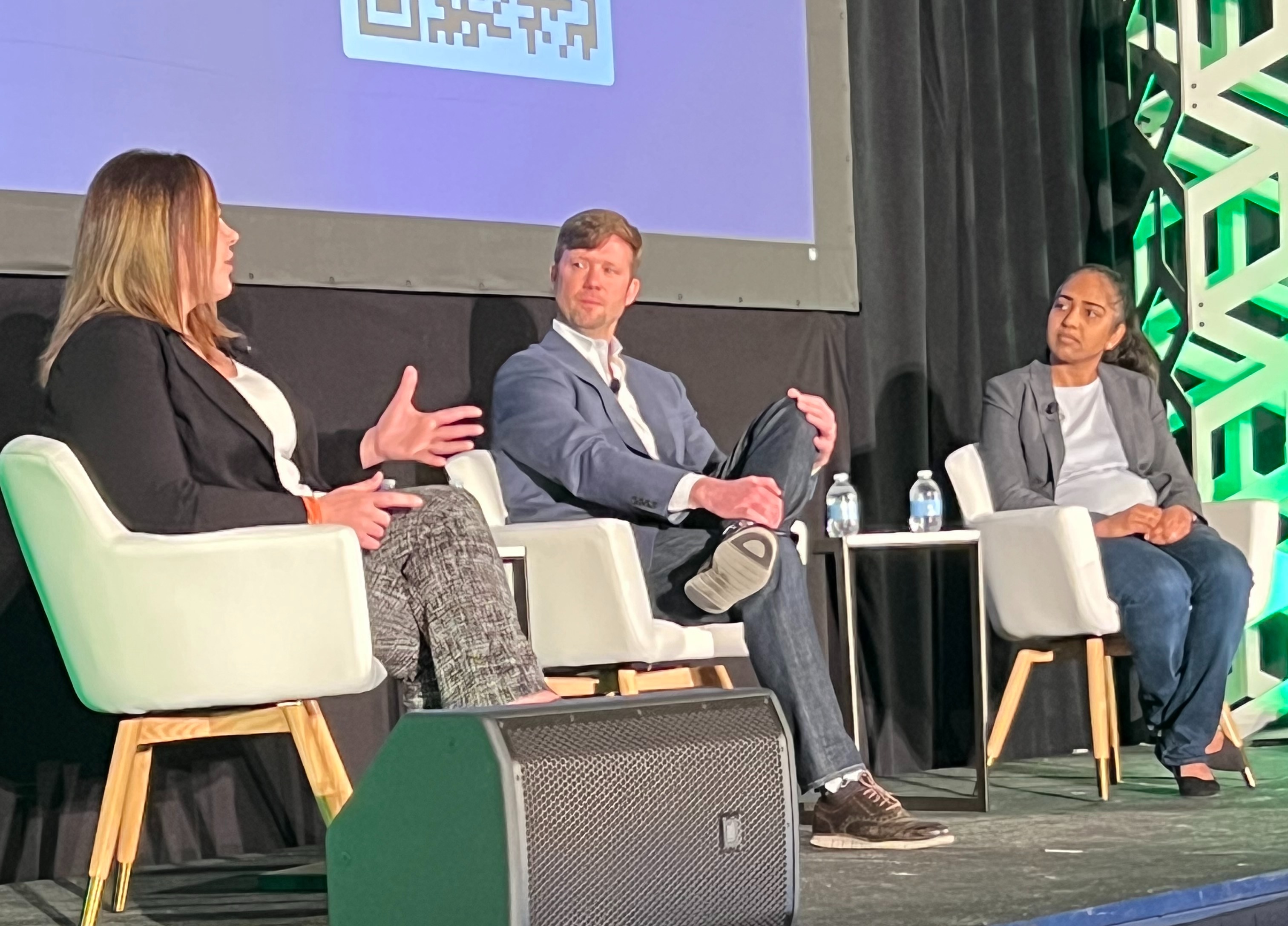 photo of 3 people speaking on stage