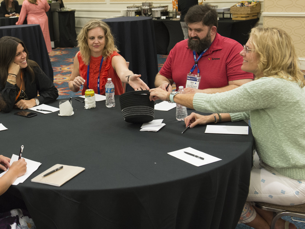 a group of people conversing around a table